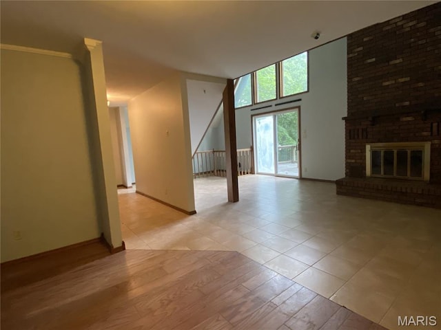 236 Mohawk Dr, Cape Girardeau, MO 63701 - unfurnished living room featuring baseboards, a fireplace, and light wood-style flooring