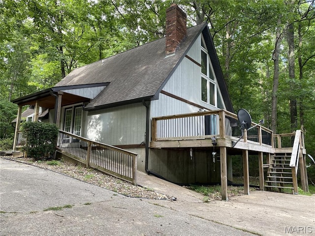 236 Mohawk Dr, Cape Girardeau, MO 63701 - view of property exterior featuring a shingled roof, a chimney, stairway, and a deck