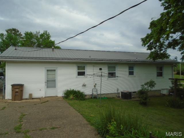 12 Tabitha Ln, Annapolis, MO 63620 - back of property featuring metal roof, a yard, central AC, and a standing seam roof