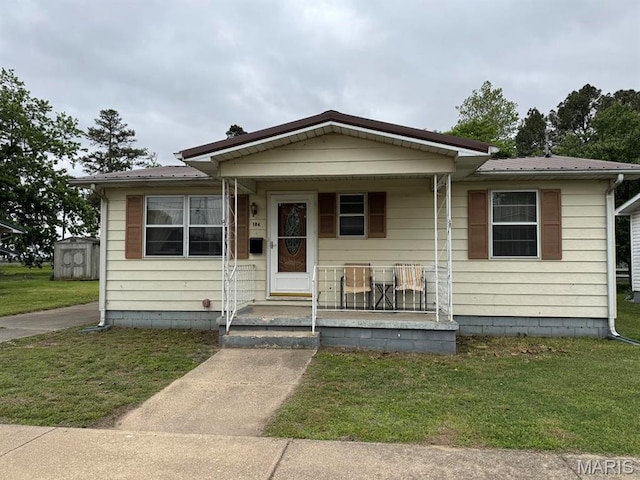 104 Day Ave, Bernie, MO 63822 - bungalow with covered porch, a front lawn, and metal roof