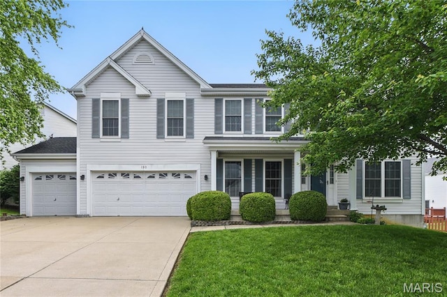 190 Abington Dr, Ofallon, MO 63376 - traditional-style home with concrete driveway, a front yard, and an attached garage