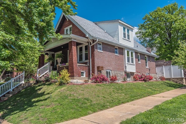 view of property exterior featuring covered porch, brick siding, and a shingled roof