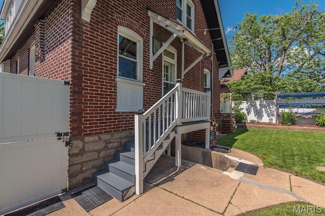 entrance to property featuring brick siding