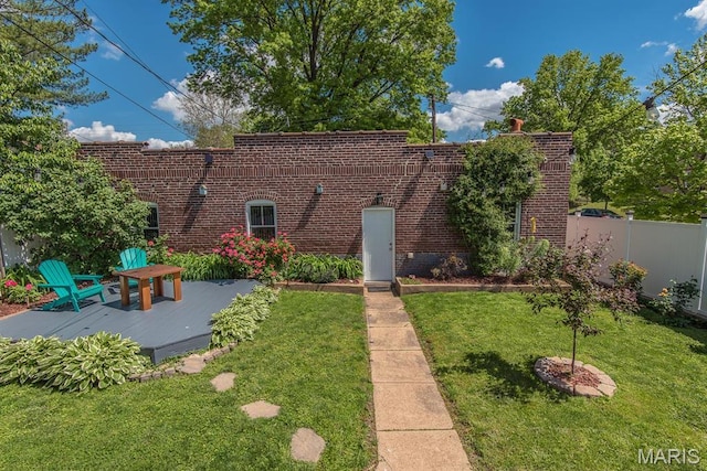 rear view of property with brick siding and a patio area