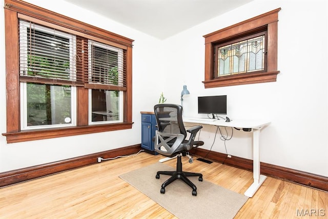 home office featuring baseboards, wood finished floors, and healthy amount of natural light