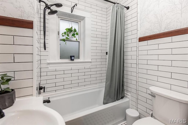 full bathroom with tile walls, toilet, wallpapered walls, and shower / bathtub combination with curtain