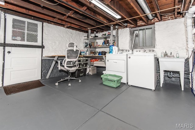 unfinished below grade area with separate washer and dryer and a sink