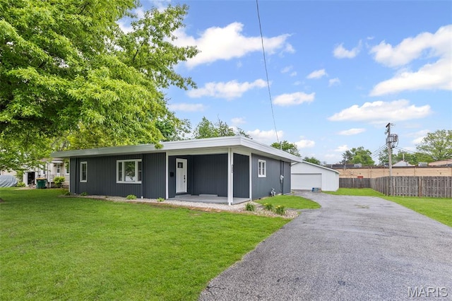 view of front of home featuring a garage and an outbuilding