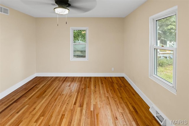 spare room featuring ceiling fan, wood finished floors, and baseboards