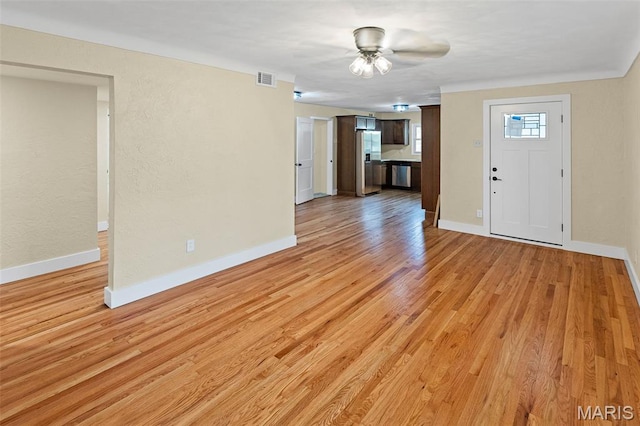 unfurnished living room with light wood-style flooring, baseboards, and ceiling fan