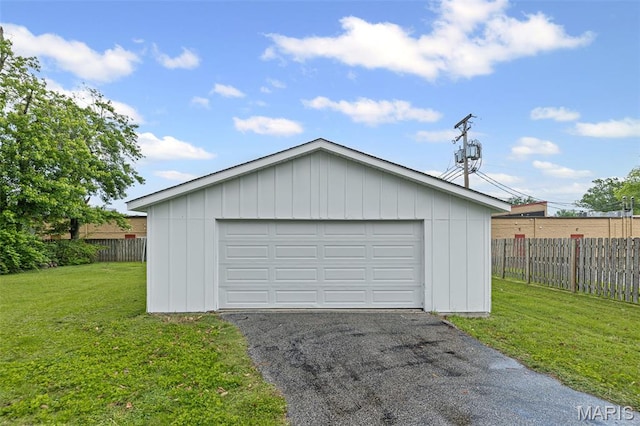 detached garage with asphalt driveway
