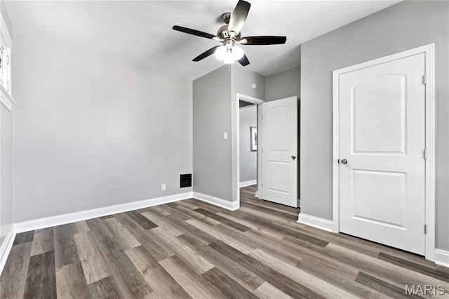 4020 Neosho St, Saint Louis, MO 63116 - unfurnished bedroom featuring wood finished floors, baseboards, and a ceiling fan