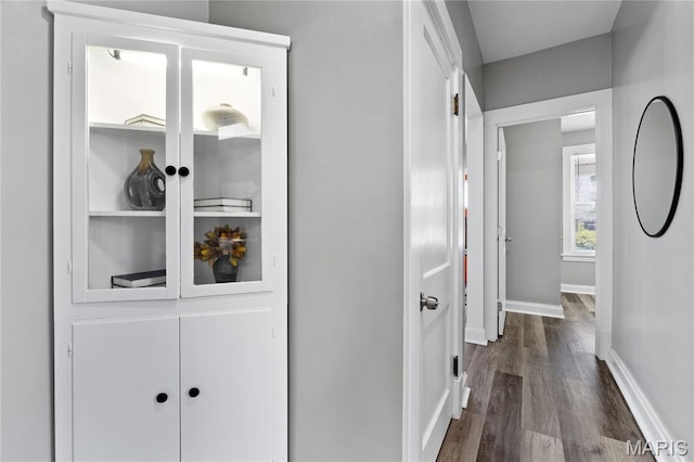 4020 Neosho St, Saint Louis, MO 63116 - hallway featuring dark wood-type flooring and baseboards