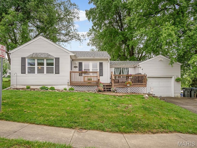 ranch-style home featuring asphalt driveway, an attached garage, a deck, and a front lawn