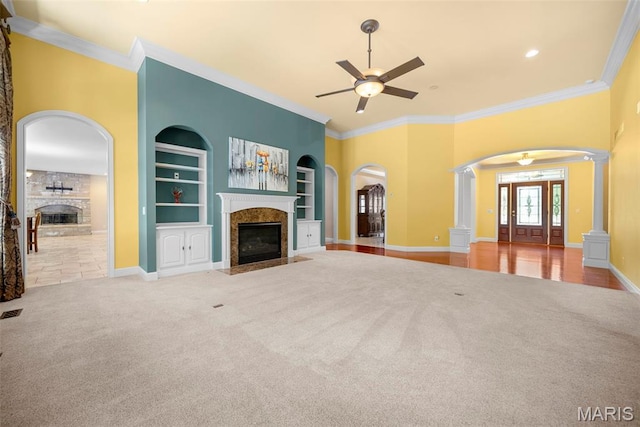 1019 Hawks Landing Dr, Lake St Louis, MO 63367 - unfurnished living room featuring a fireplace, ceiling fan, carpet flooring, and ornamental molding