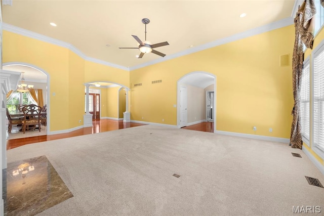 1019 Hawks Landing Dr, Lake St Louis, MO 63367 - unfurnished living room featuring arched walkways, ceiling fan, ornamental molding, carpet floors, and ornate columns