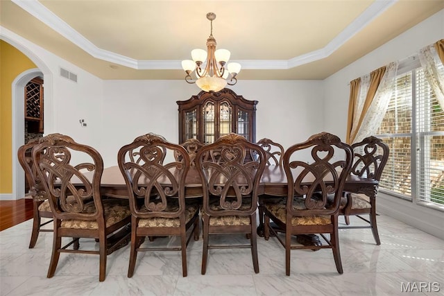 1019 Hawks Landing Dr, Lake St Louis, MO 63367 - dining room with a chandelier, a tray ceiling, crown molding, arched walkways, and light marble finish floors