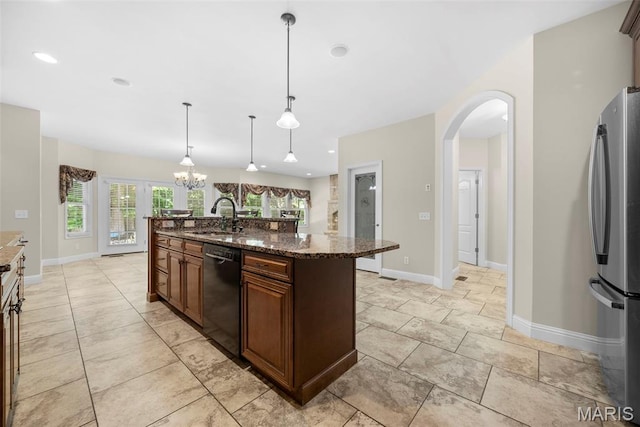 1019 Hawks Landing Dr, Lake St Louis, MO 63367 - kitchen featuring black dishwasher, freestanding refrigerator, a sink, arched walkways, and a chandelier