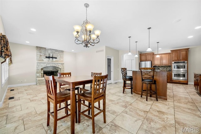 1019 Hawks Landing Dr, Lake St Louis, MO 63367 - dining room featuring baseboards, recessed lighting, a fireplace, and a chandelier