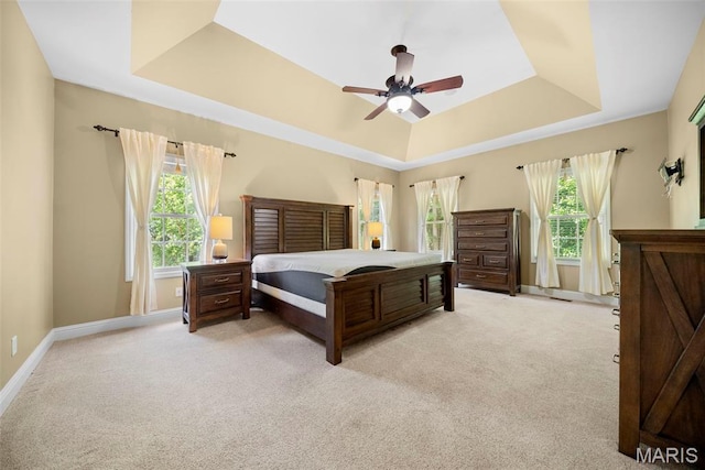 1019 Hawks Landing Dr, Lake St Louis, MO 63367 - bedroom with a tray ceiling, light carpet, baseboards, and ceiling fan