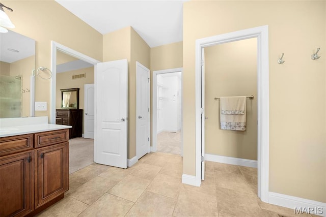1019 Hawks Landing Dr, Lake St Louis, MO 63367 - bathroom with vanity, a shower with door, baseboards, and tile patterned floors