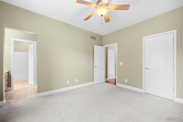 1019 Hawks Landing Dr, Lake St Louis, MO 63367 - unfurnished bedroom featuring light carpet, baseboards, connected bathroom, and a ceiling fan