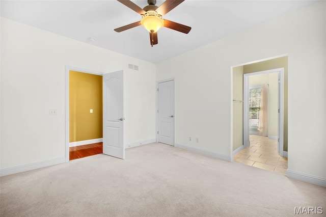 1019 Hawks Landing Dr, Lake St Louis, MO 63367 - unfurnished bedroom with light colored carpet, baseboards, and a ceiling fan