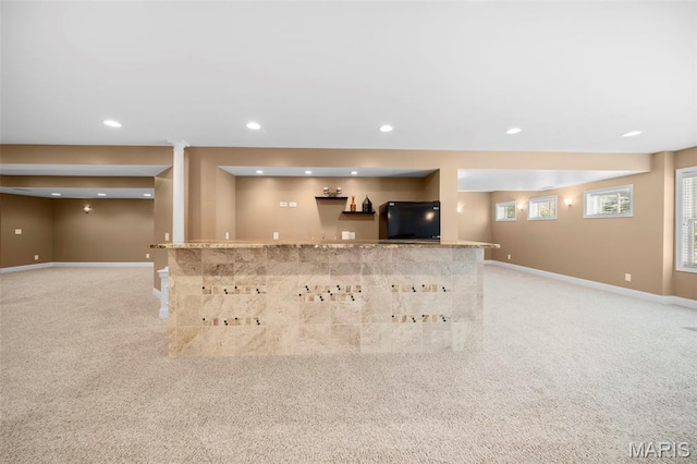 1019 Hawks Landing Dr, Lake St Louis, MO 63367 - unfurnished living room featuring bar with sink, light colored carpet, recessed lighting, and baseboards