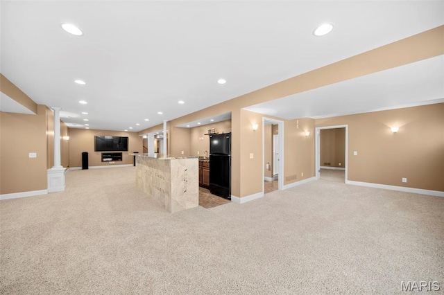 1019 Hawks Landing Dr, Lake St Louis, MO 63367 - kitchen with open floor plan, freestanding refrigerator, light colored carpet, ornate columns, and baseboards