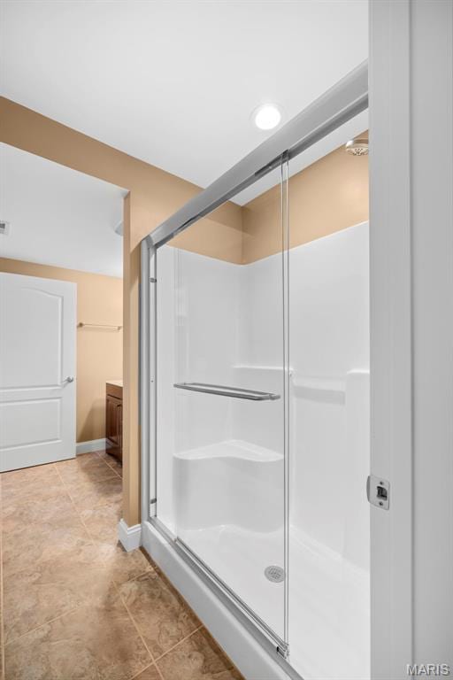 1019 Hawks Landing Dr, Lake St Louis, MO 63367 - bathroom with a stall shower, tile patterned flooring, and baseboards