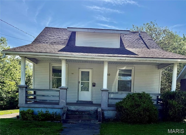 bungalow-style house with a porch and a shingled roof