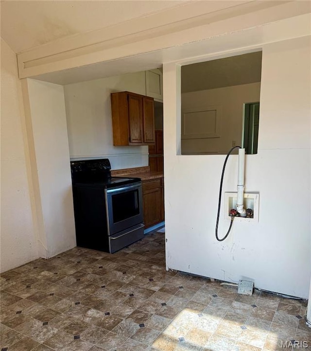kitchen with electric stove and brown cabinets