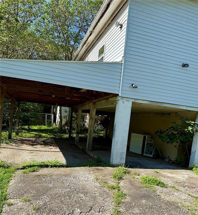 view of home's exterior with dirt driveway