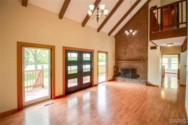968 Super Slab Rd, Greenfield, IL 62044 - unfurnished living room featuring a chandelier, high vaulted ceiling, beam ceiling, light wood finished floors, and french doors