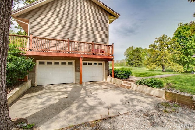 968 Super Slab Rd, Greenfield, IL 62044 - view of side of home featuring a lawn, an attached garage, a deck, and concrete driveway