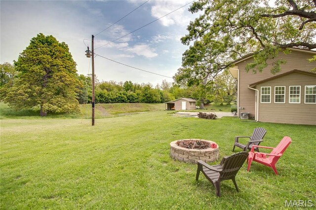 968 Super Slab Rd, Greenfield, IL 62044 - view of grassy yard with an outdoor fire pit and an outbuilding