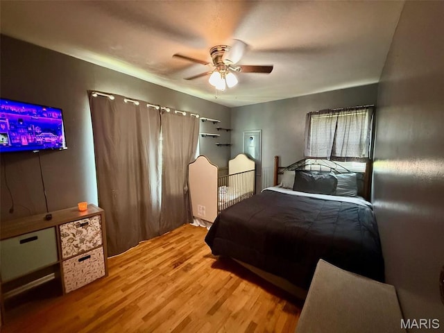 bedroom with wood finished floors and ceiling fan