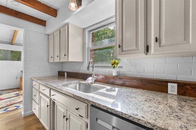 1353 Karen Dr, Cape Girardeau, MO 63701 - kitchen featuring a sink, plenty of natural light, light stone counters, wood finished floors, and beamed ceiling