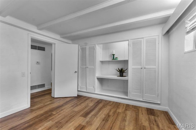 1353 Karen Dr, Cape Girardeau, MO 63701 - unfurnished bedroom featuring beamed ceiling, wood finished floors, baseboards, and a closet