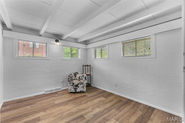 1353 Karen Dr, Cape Girardeau, MO 63701 - unfurnished room featuring brick wall, beamed ceiling, wood finished floors, and baseboards
