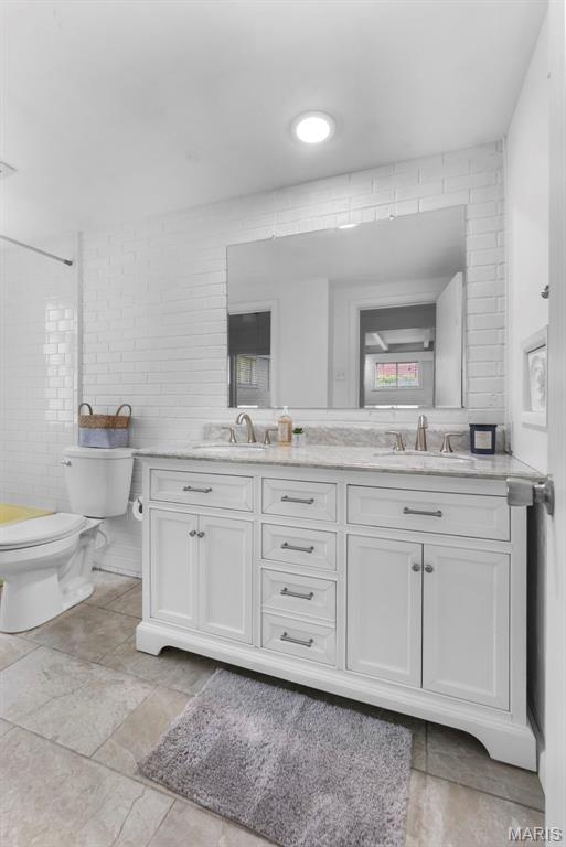 1353 Karen Dr, Cape Girardeau, MO 63701 - bathroom with toilet, double vanity, and a shower