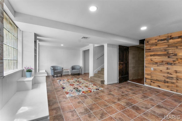 1353 Karen Dr, Cape Girardeau, MO 63701 - below grade area featuring stairway, recessed lighting, wooden walls, and dark tile patterned floors