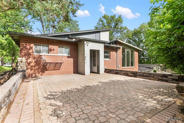 1353 Karen Dr, Cape Girardeau, MO 63701 - rear view of house featuring brick siding and a patio