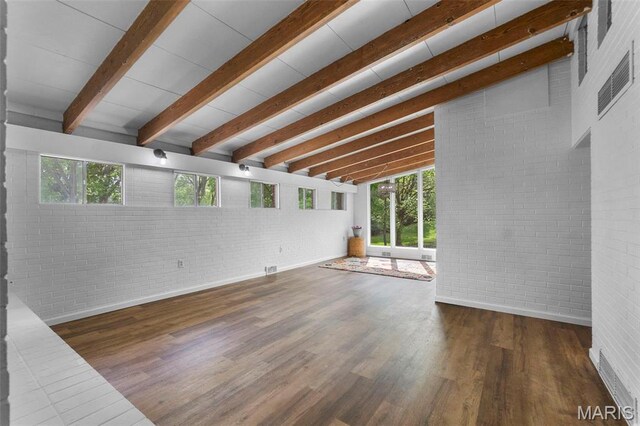1353 Karen Dr, Cape Girardeau, MO 63701 - unfurnished living room with plenty of natural light, brick wall, wood finished floors, and baseboards