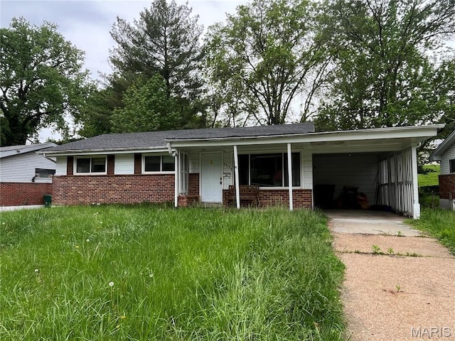 9915 Castle Dr, Saint Louis, MO 63136 - ranch-style home with driveway, brick siding, covered porch, and a carport