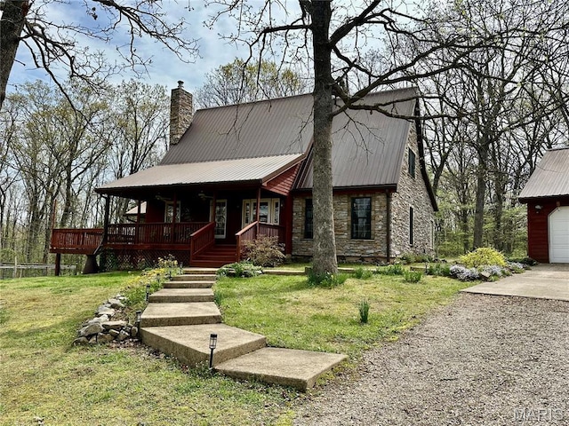 15716 County Road 5190, Rolla, MO 65401 - view of front of house featuring stone siding, a porch, a chimney, a front yard, and metal roof