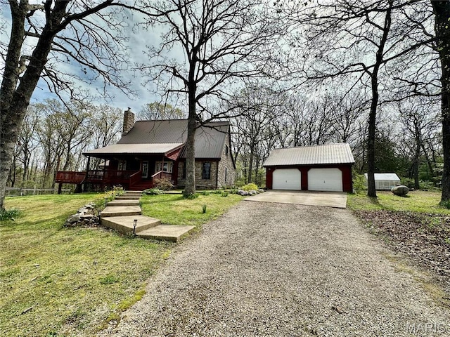 15716 County Road 5190, Rolla, MO 65401 - view of front facade with a chimney, an outdoor structure, a front yard, a porch, and gravel driveway