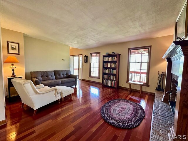 15716 County Road 5190, Rolla, MO 65401 - living area featuring hardwood / wood-style flooring, a brick fireplace, and baseboards