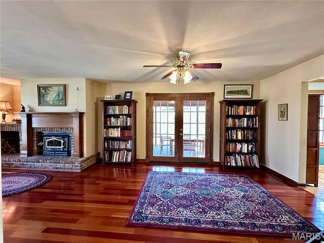 15716 County Road 5190, Rolla, MO 65401 - living area with a brick fireplace, french doors, a ceiling fan, wood finished floors, and baseboards