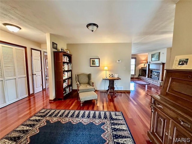 15716 County Road 5190, Rolla, MO 65401 - living area with wood finished floors, a brick fireplace, and baseboards